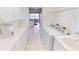 Bright laundry room featuring tile floors, white cabinets, modern appliances, and access to the screened-in porch at 26089 Seminole Lakes Blvd, Punta Gorda, FL 33955