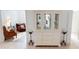 Bright living room featuring a china cabinet, display shelves, tiled floors, and neutral color palette at 26089 Seminole Lakes Blvd, Punta Gorda, FL 33955