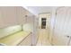 Hallway view with white cabinetry and appliances with access to garage at 26089 Seminole Lakes Blvd, Punta Gorda, FL 33955