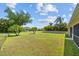 Lush, green backyard featuring mature trees and well-maintained lawn at 27038 San Jorge Dr, Punta Gorda, FL 33983