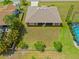 Aerial view of a spacious backyard with lush landscaping and a screened lanai, perfect for outdoor enjoyment at 27038 San Jorge Dr, Punta Gorda, FL 33983