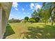 Expansive backyard with a lush green lawn and tropical landscaping at 27038 San Jorge Dr, Punta Gorda, FL 33983