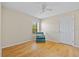 Cozy bedroom featuring hardwood floors, a comfortable chair, and bright natural lighting at 27038 San Jorge Dr, Punta Gorda, FL 33983