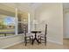 Breakfast nook by the window features a small table and two chairs, perfect for enjoying the morning light at 27038 San Jorge Dr, Punta Gorda, FL 33983