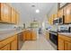 Kitchen includes stainless steel appliances and wood cabinets with views into the living spaces at 27038 San Jorge Dr, Punta Gorda, FL 33983