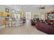 Open-concept living room features a view of the kitchen, breakfast bar, and the front door with lots of natural light at 27038 San Jorge Dr, Punta Gorda, FL 33983
