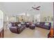 Spacious living room with tile flooring, comfortable seating, and a ceiling fan for added comfort at 27038 San Jorge Dr, Punta Gorda, FL 33983