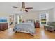 Main bedroom features wood floors, a ceiling fan, two windows, and is bright and spacious at 27038 San Jorge Dr, Punta Gorda, FL 33983