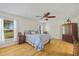 The Main bedroom boasts wood floors, a ceiling fan, and lots of natural light from the large windows at 27038 San Jorge Dr, Punta Gorda, FL 33983