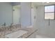 Bathroom featuring a shower, modern fixtures, granite counters, and new floors at 27050 Pelotas Dr, Punta Gorda, FL 33983