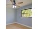 Bedroom with new floors, paint, and a ceiling fan and window at 27050 Pelotas Dr, Punta Gorda, FL 33983