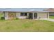 Charming house with stone accents, a metal roof, and a well-manicured front lawn at 27050 Pelotas Dr, Punta Gorda, FL 33983