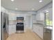 Beautiful open kitchen with stainless steel appliances, granite countertops, and white shaker cabinets at 27050 Pelotas Dr, Punta Gorda, FL 33983