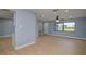 Spacious living room with an open concept design, featuring light wood flooring and modern blue walls at 27050 Pelotas Dr, Punta Gorda, FL 33983