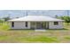 The home's rear exterior features sliding glass doors with backyard at 27050 Pelotas Dr, Punta Gorda, FL 33983