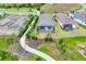 Aerial view of the property, showcasing a paved walkway, screened lanai, and landscaping at 281 Potenza Loop, Nokomis, FL 34275
