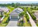 Lovely aerial view showcasing the home's setting near a serene lake and walking paths at 281 Potenza Loop, Nokomis, FL 34275