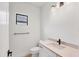 Bathroom showcases a vanity with modern fixtures, a toilet, and a window for natural light at 281 Potenza Loop, Nokomis, FL 34275