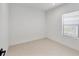 Bright, window-lit bedroom with neutral tile floors and fresh, white walls at 281 Potenza Loop, Nokomis, FL 34275
