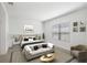 Bright bedroom showcases a comfortable queen bed, stylish decor, and an inviting seating area by the window at 281 Potenza Loop, Nokomis, FL 34275