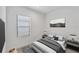 This bedroom features neutral decor, a window, and a comfortable bed with side tables at 281 Potenza Loop, Nokomis, FL 34275