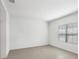 A bright and airy bedroom features tile flooring, a large window, and fresh white walls at 281 Potenza Loop, Nokomis, FL 34275