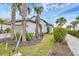 Charming home with well-maintained landscaping, palm trees, and a brick walkway leading to the entrance at 281 Potenza Loop, Nokomis, FL 34275