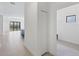 Bright and airy hallway leading to the open living spaces with tiled flooring at 281 Potenza Loop, Nokomis, FL 34275