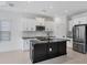 Modern kitchen with stainless steel appliances and a large island at 281 Potenza Loop, Nokomis, FL 34275