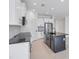 Modern kitchen with an island and stainless steel appliances at 281 Potenza Loop, Nokomis, FL 34275