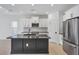 Updated kitchen featuring a large island, stainless appliances, and sleek design at 281 Potenza Loop, Nokomis, FL 34275
