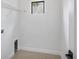 A plain white laundry room with a small window at 281 Potenza Loop, Nokomis, FL 34275
