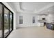 Open-concept living area with kitchen access and sliding glass doors to the outside at 281 Potenza Loop, Nokomis, FL 34275