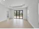 Bright living room with tiled flooring and large glass doors at 281 Potenza Loop, Nokomis, FL 34275