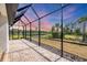 Enjoy the spacious screened-in patio with views of the lake and surrounding greenery at 281 Potenza Loop, Nokomis, FL 34275