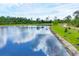 Scenic aerial view of a pond with vibrant blue water and lush green surroundings at 281 Potenza Loop, Nokomis, FL 34275