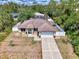 Aerial view of home with a long drive and big front lawn at 3021 Toluca Ter, North Port, FL 34286