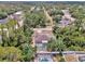 Aerial view of a home with a screened-in pool surrounded by trees at 3021 Toluca Ter, North Port, FL 34286