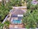 Aerial view of home with private screened pool and fenced yard at 3021 Toluca Ter, North Port, FL 34286