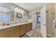 Bathroom featuring double sink with granite countertops, and wooden cabinets at 3021 Toluca Ter, North Port, FL 34286