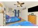 Bedroom with ceiling fan and two twin beds with galaxy design bedding at 3021 Toluca Ter, North Port, FL 34286