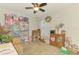 Bedroom with neutral walls, ceiling fan, and window providing natural light at 3021 Toluca Ter, North Port, FL 34286