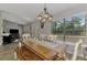 Open dining area with modern chandelier, wood floors, and large window views at 3021 Toluca Ter, North Port, FL 34286