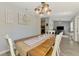 Dining area with wood table, decor, and an open view to the living room and kitchen at 3021 Toluca Ter, North Port, FL 34286