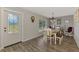 A cozy dining room features wood floors, a chandelier, and farmhouse-style decor and seating at 3021 Toluca Ter, North Port, FL 34286