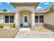 A welcoming front entrance has stone pillars, a decorative door, and tasteful landscaping at 3021 Toluca Ter, North Port, FL 34286