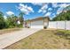 Inviting single-story home with a two car garage, enhanced by a long driveway and partially fenced yard at 3021 Toluca Ter, North Port, FL 34286