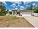 Charming single-story home with a two car garage and a well-manicured lawn at 3021 Toluca Ter, North Port, FL 34286