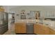 Kitchen with stainless steel dishwasher, granite countertops, sink and wooden cabinets at 3021 Toluca Ter, North Port, FL 34286