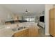 Spacious kitchen looking into the living room and pool views at 3021 Toluca Ter, North Port, FL 34286